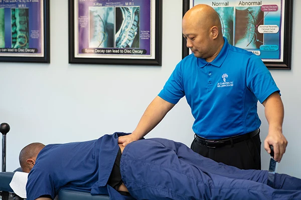 Chiropractor Durham NC Sanghyun Ju Adjusting Patient Lower Back